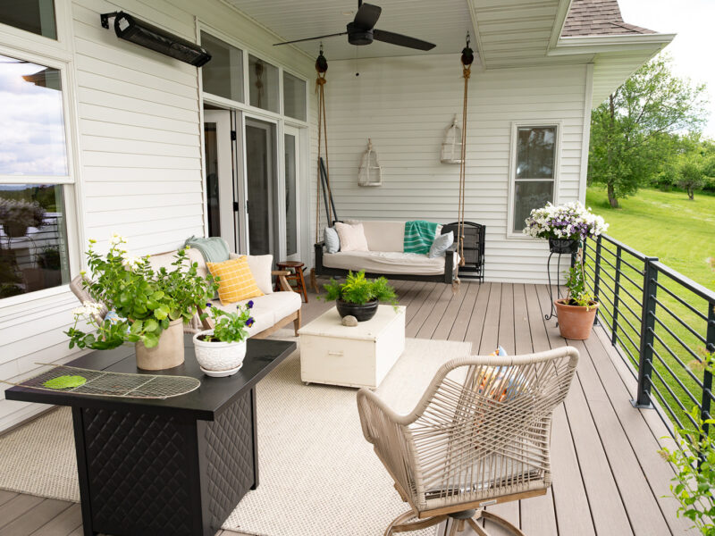 Ranch style front porch with a seating area and custom black railings