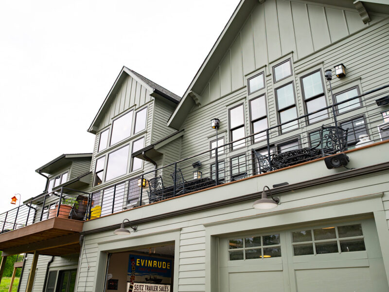 Back end of a custom green lake house in North Liberty, Iowa